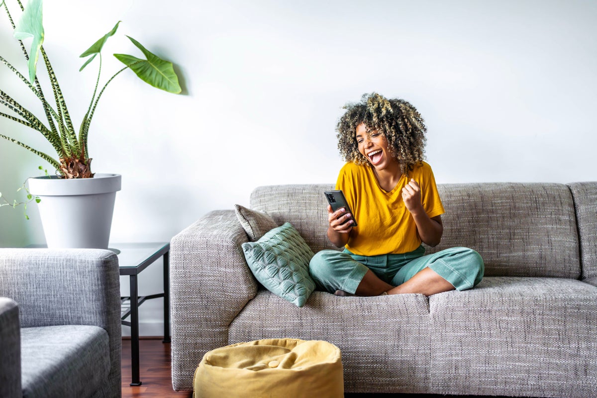 Excited woman shopping online with phone