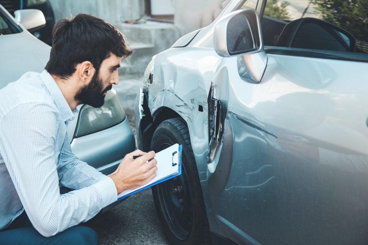 Man hand documenting car crash accident